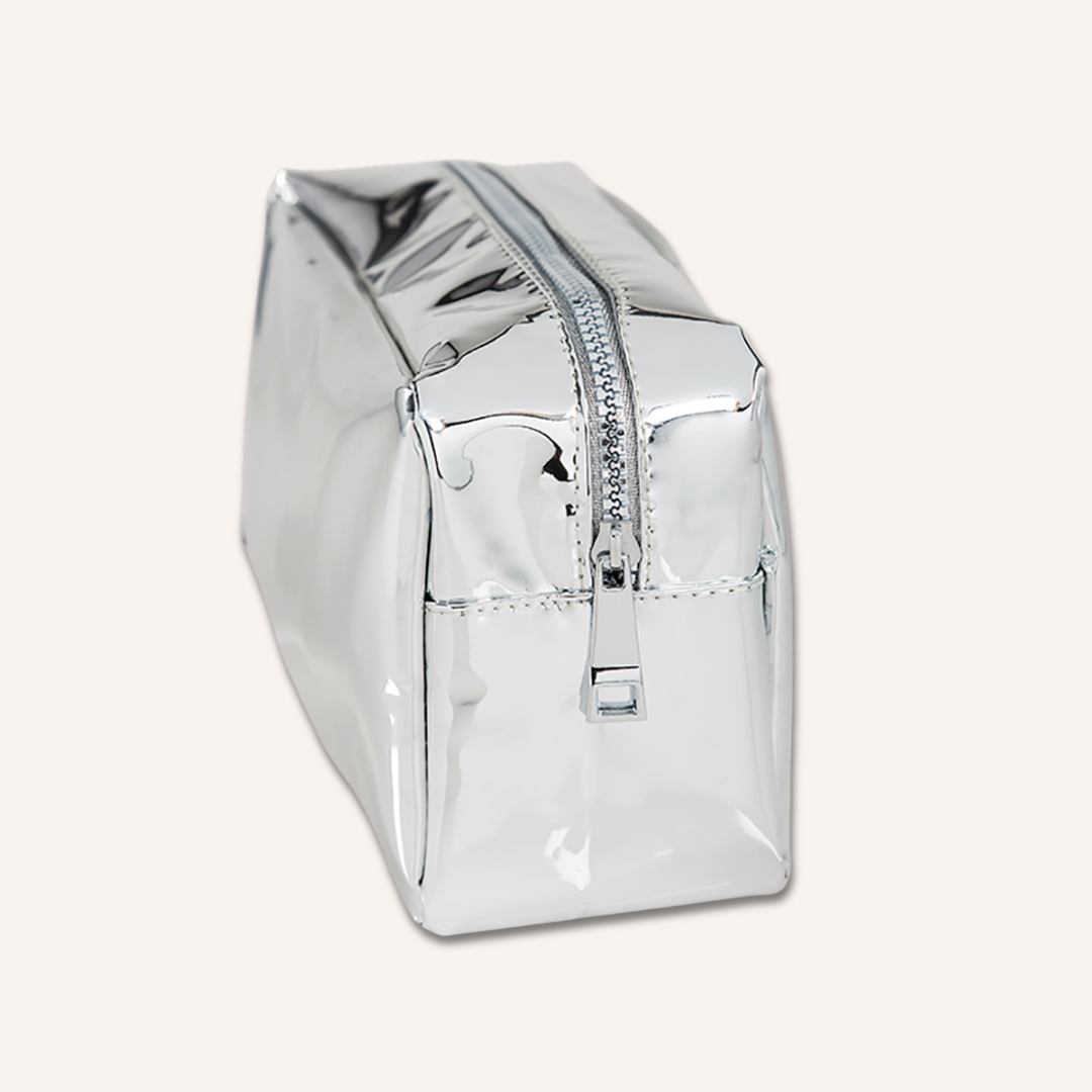 Side view of the metallic silver Woosh Beauty essential makeup bag