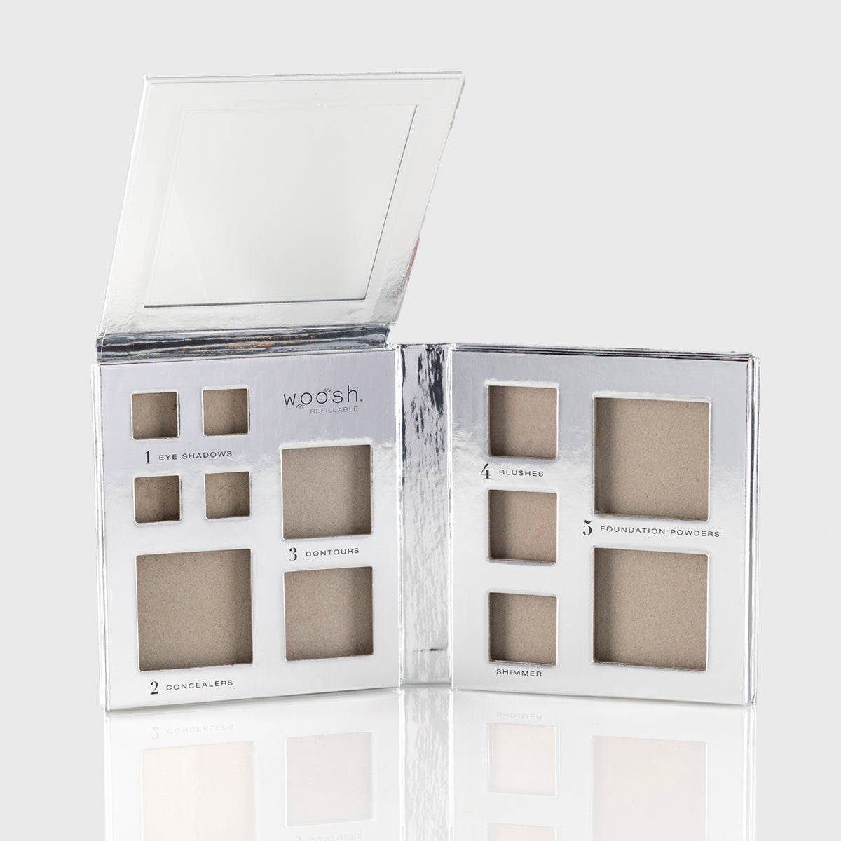 a photo of an empty silver makeup palette with mirrored flap and slots for 13 different cosmetic products