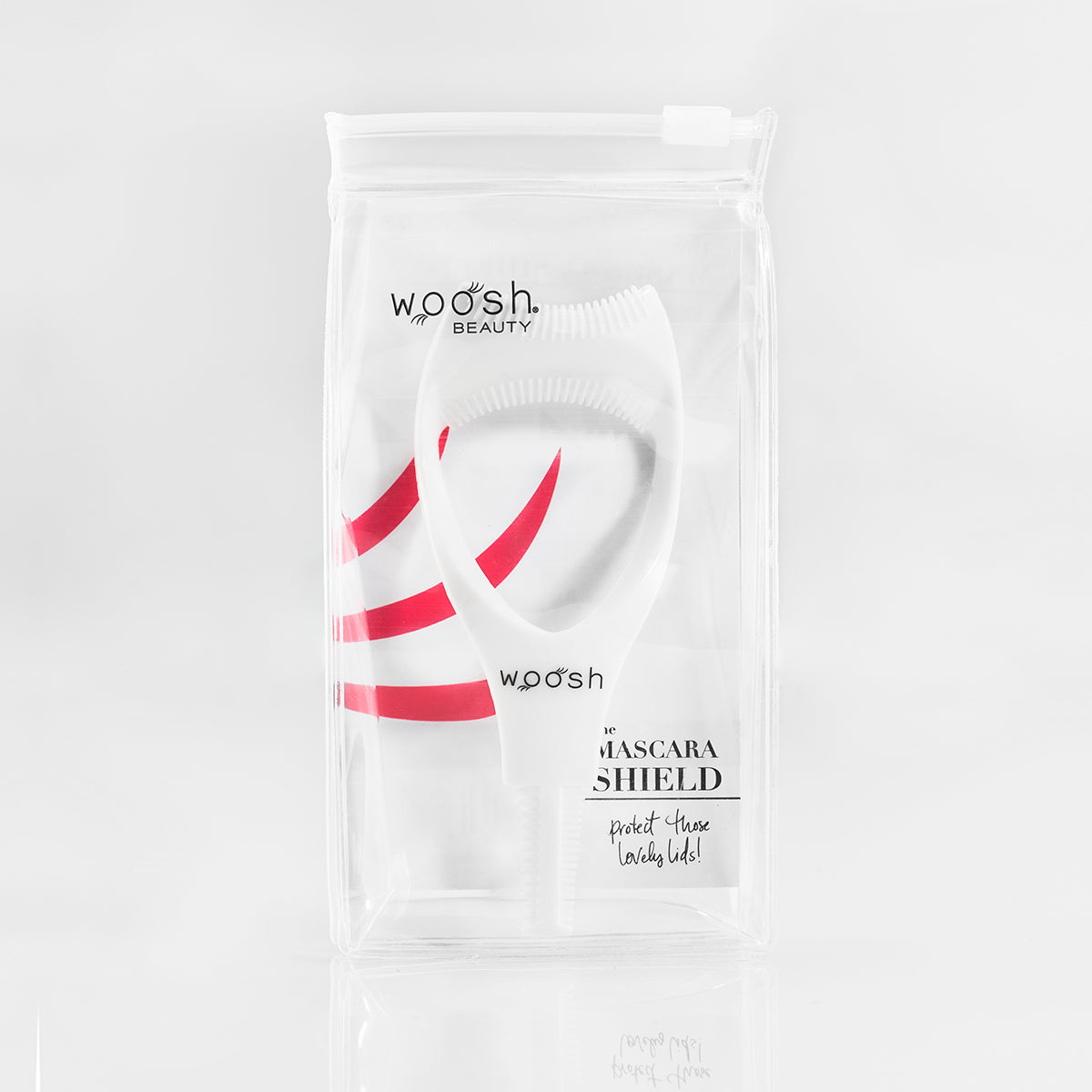 The white, flexible, plastic mascara shield in reusable package.