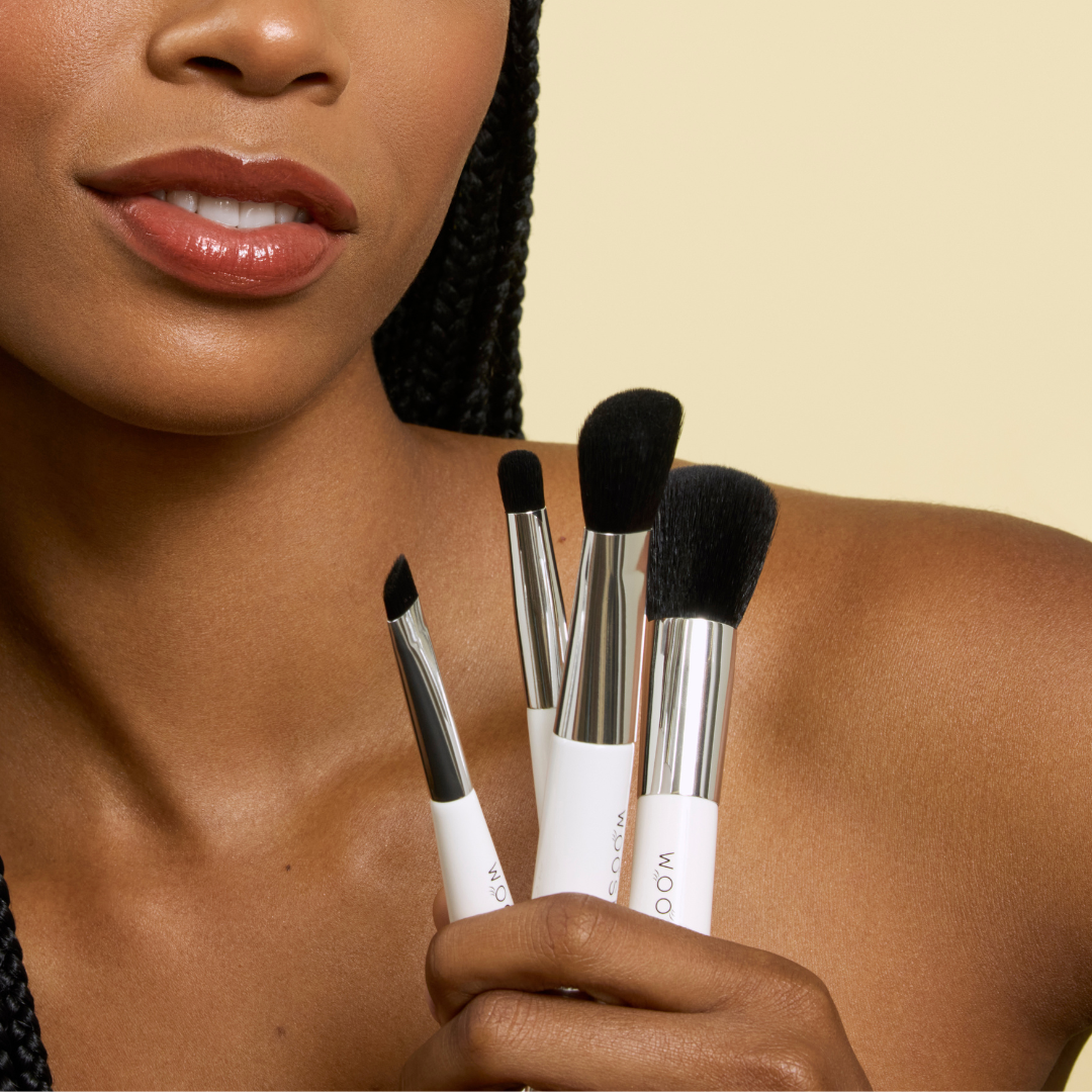 model holding our 4 dual ended essential brush set