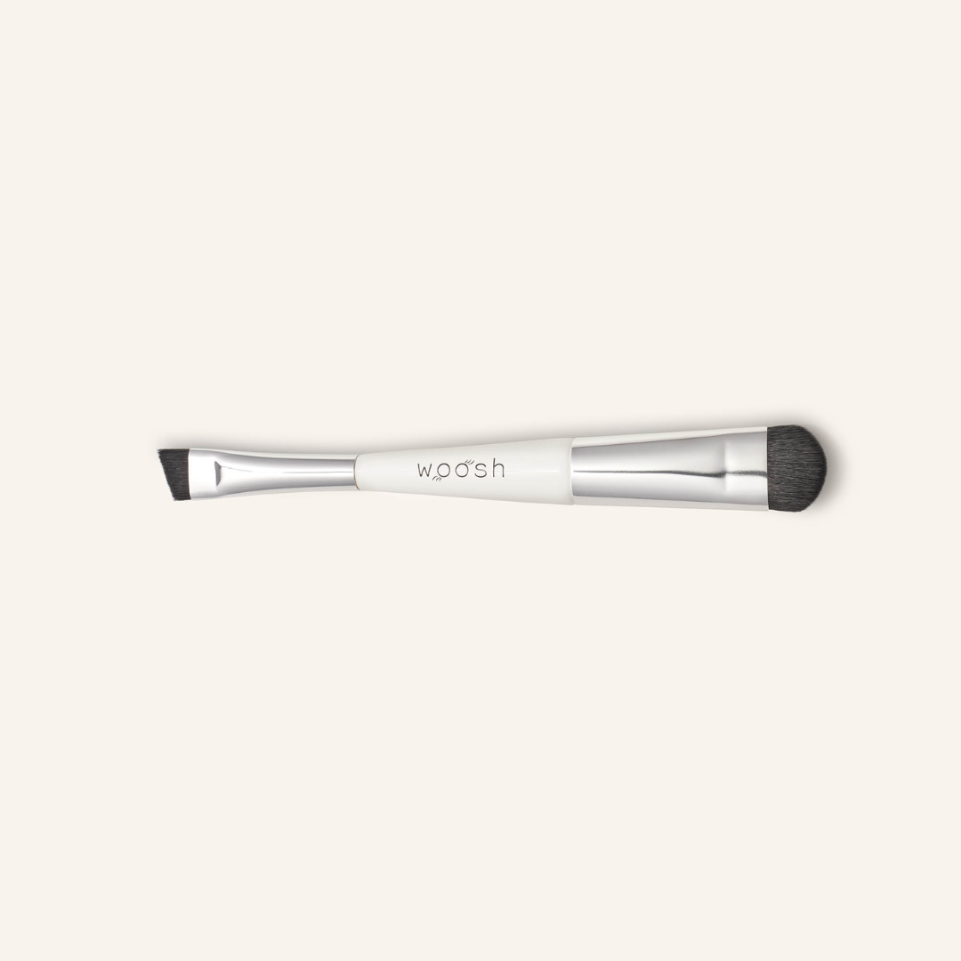 the dual ended eye brush with domed end facing down and angeled liner end facing up