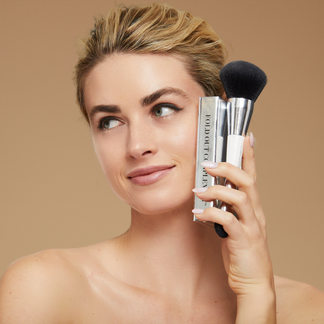 Model holding complexion brush with our face palette