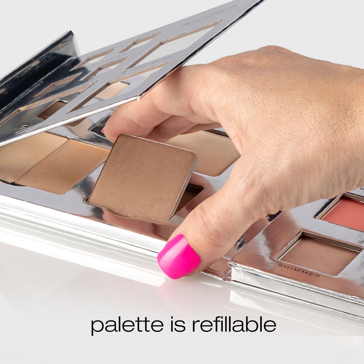 Model hand putting a pan into the palette showing it is refillable