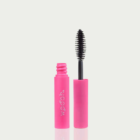 mini mascara bottle image. mascara is open showing off the unique almond shaped applicator.