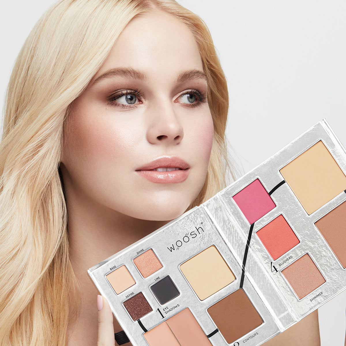 a photo of a fair-skinned model wearing beautiful, natural-looking makeup holding the Fold Out Face palette in shade #1 light