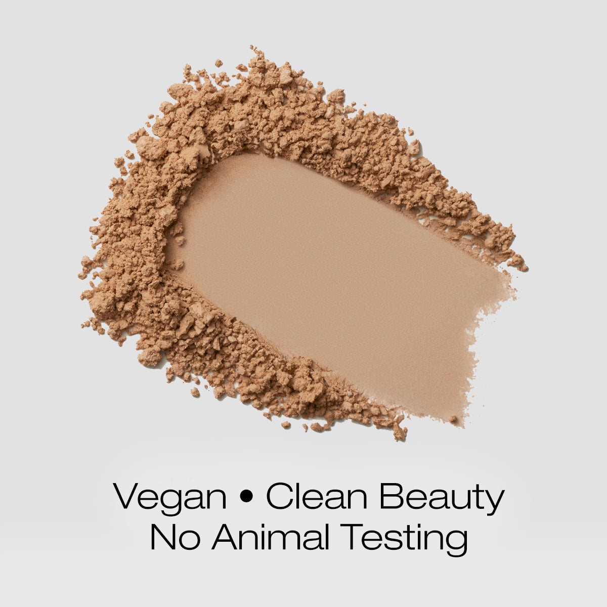 a swatch of tan colored foundation powder indicating that the formula is vegan, clean beauty and is not tested on animals
