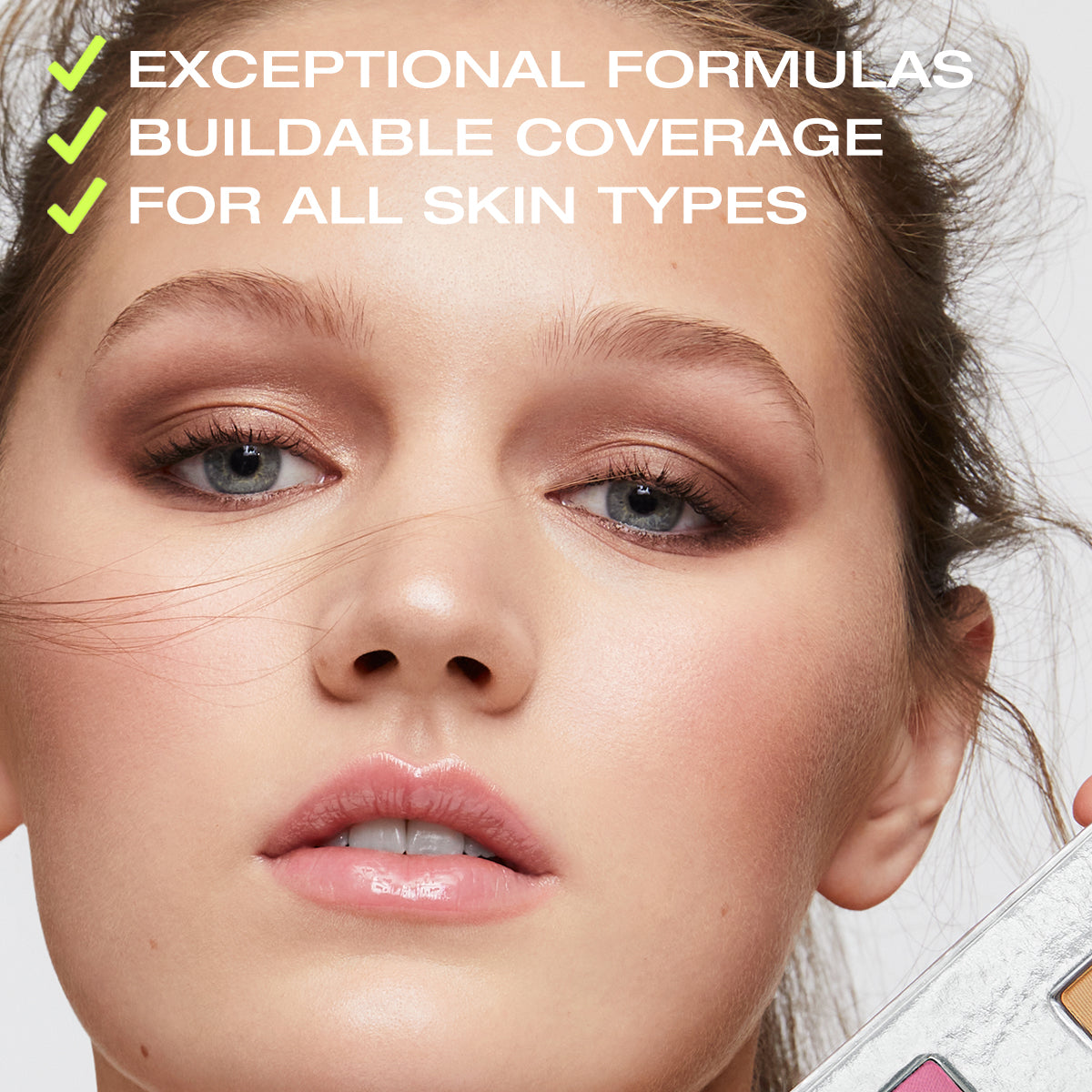 a photo of a beautiful woman with copy on top stating that the coverage in the Fold Out Face is buildable, and the formulas are clean & good for all skin types
