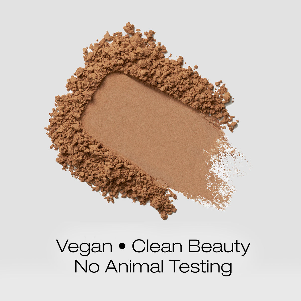 a swatch of tan colored foundation powder indicating that the formula is vegan, clean beauty and is not tested on animals