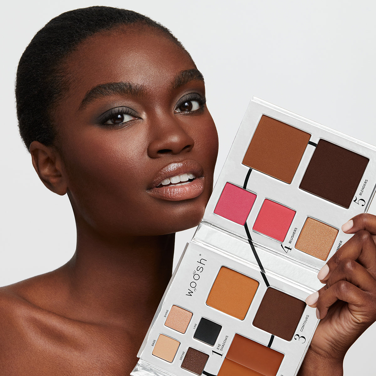 a photo of a very dark skinned African model wearing beautiful, natural-looking makeup holding the Fold Out Face palette in shade #5 deep