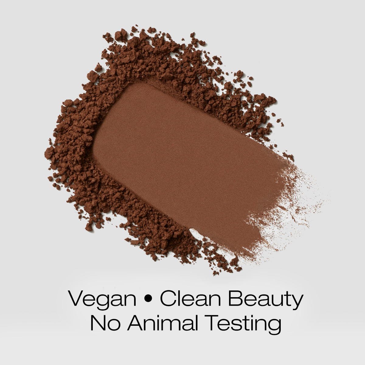 a swatch of rich dark brown colored foundation powder indicating that the formula is vegan, clean beauty and is not tested on animals