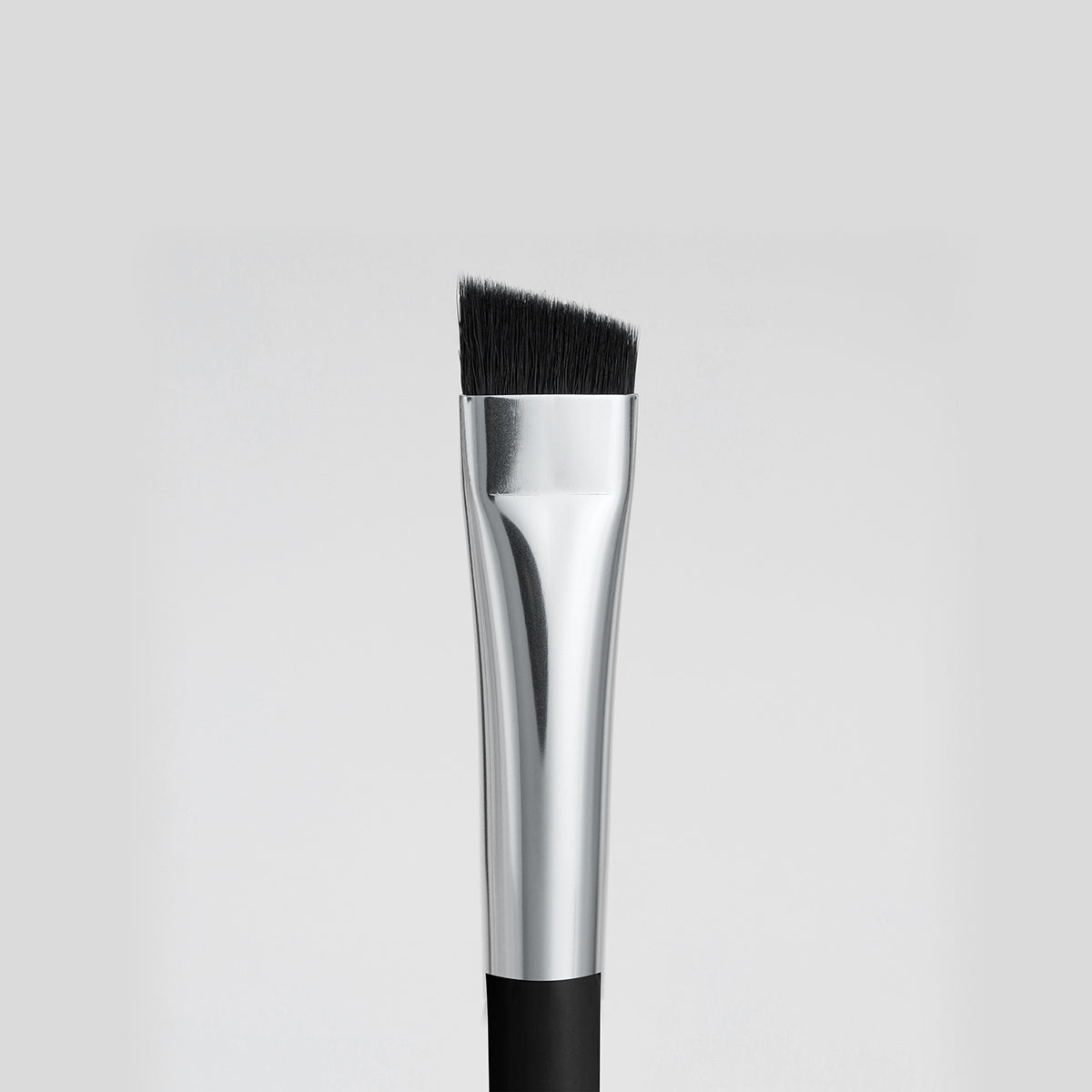 Close up image of the smaller, angled end of the double-ended Arc brush.