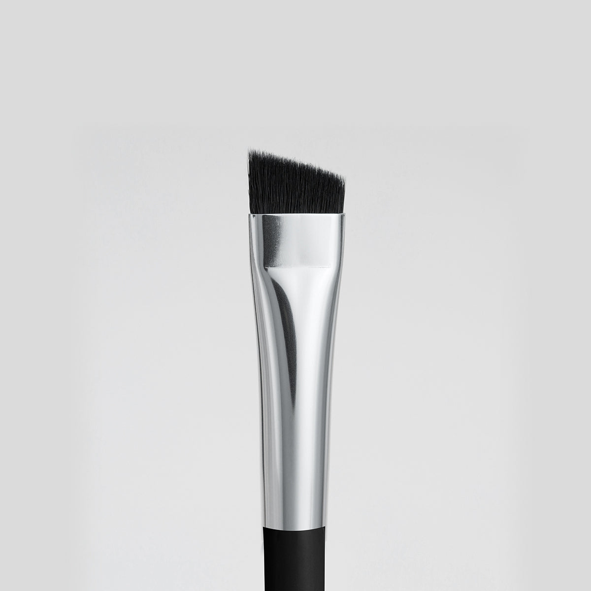 Close up image of the short, angled end of the double-ended Corner Brush. used to line eyes. 
