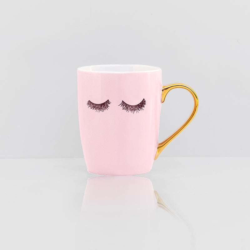 Pink eyelashes coffee mug with gold handle and white trim interior