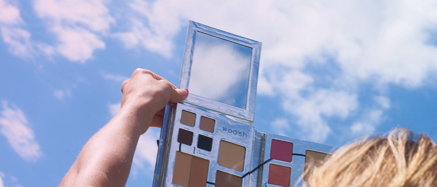 Model holding the Fold Out Face Palette in the sky