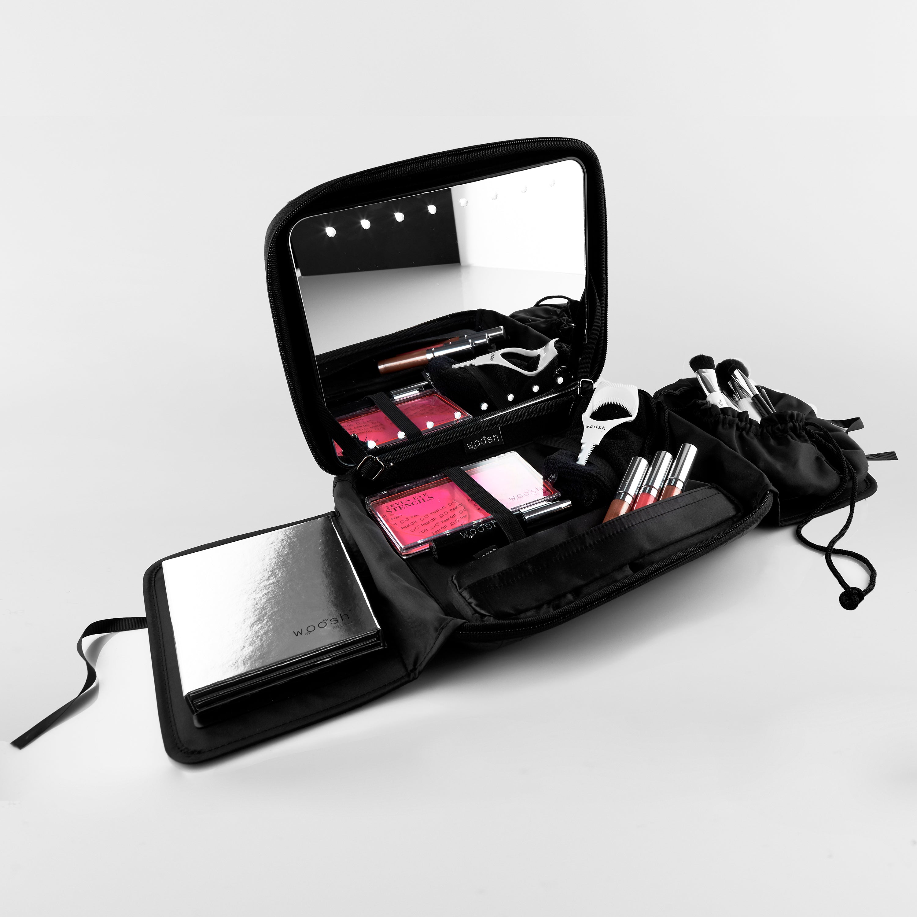 MMS Mobile Makeup System Bag opened that holds a mirror, the Fold Out Face Palette, Three Spin-On lip glosses, 4 essential makeup brushes and more!