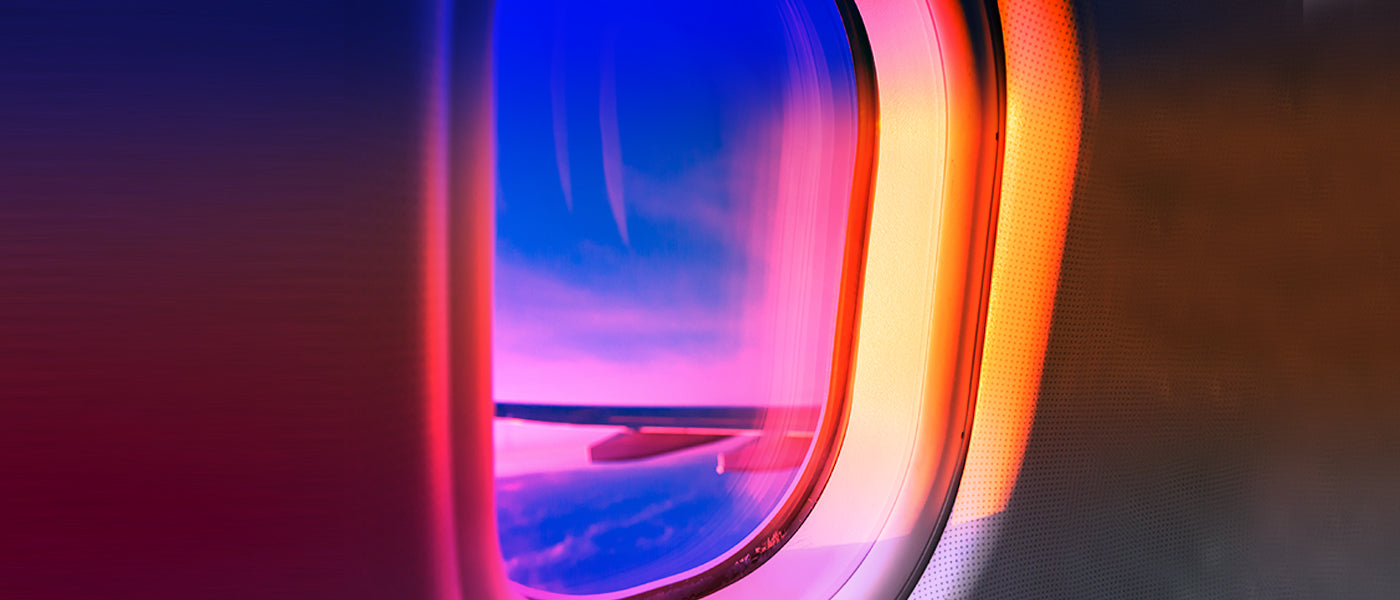 Airplane window at sunset