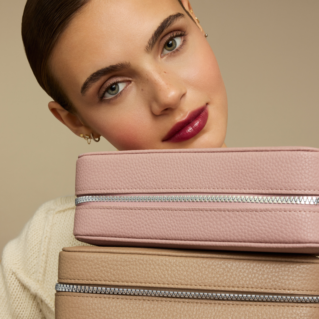 image of model with two of our fold out cases in shade mauve and sand