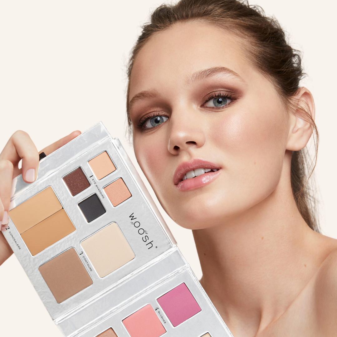 Fair skinned model with Fold out face palette open showing off the product