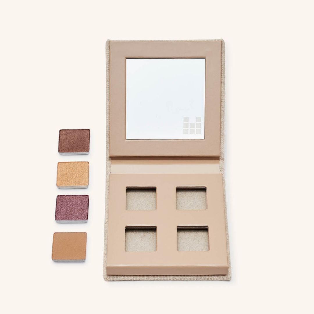 Eyeshadows next to fold out eyes palette showing refillability