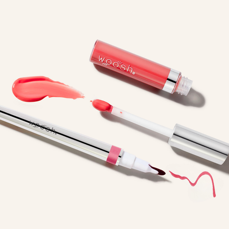 Woosh Beauty's monogamous lip stain in shade devoted with spin on gloss shade splash. Image shows the components open showing the tips of each applicator and their swatches.