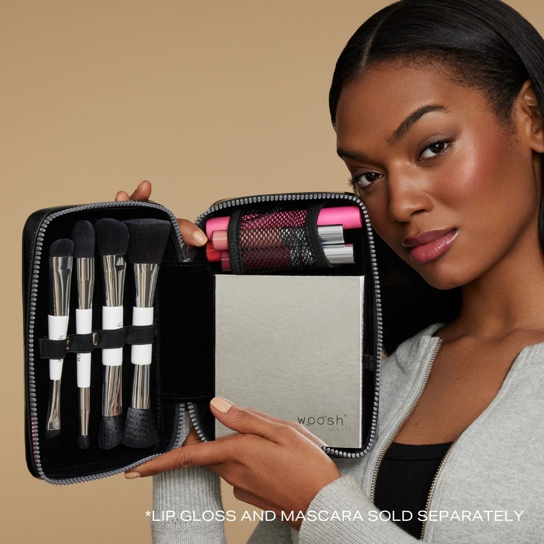 Model holding black case  showing palette and brushes fit inside