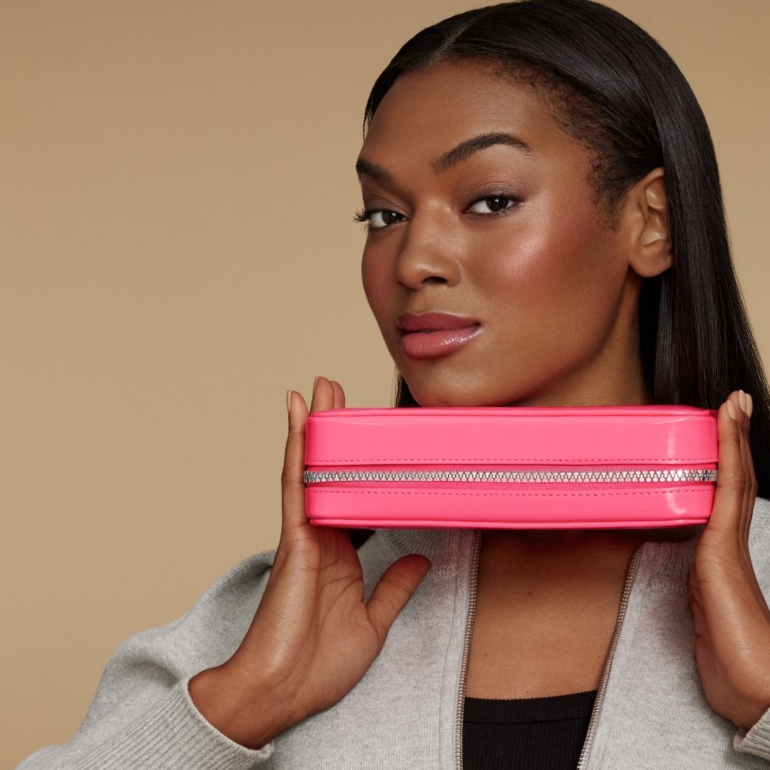 Model holding hot pink case 