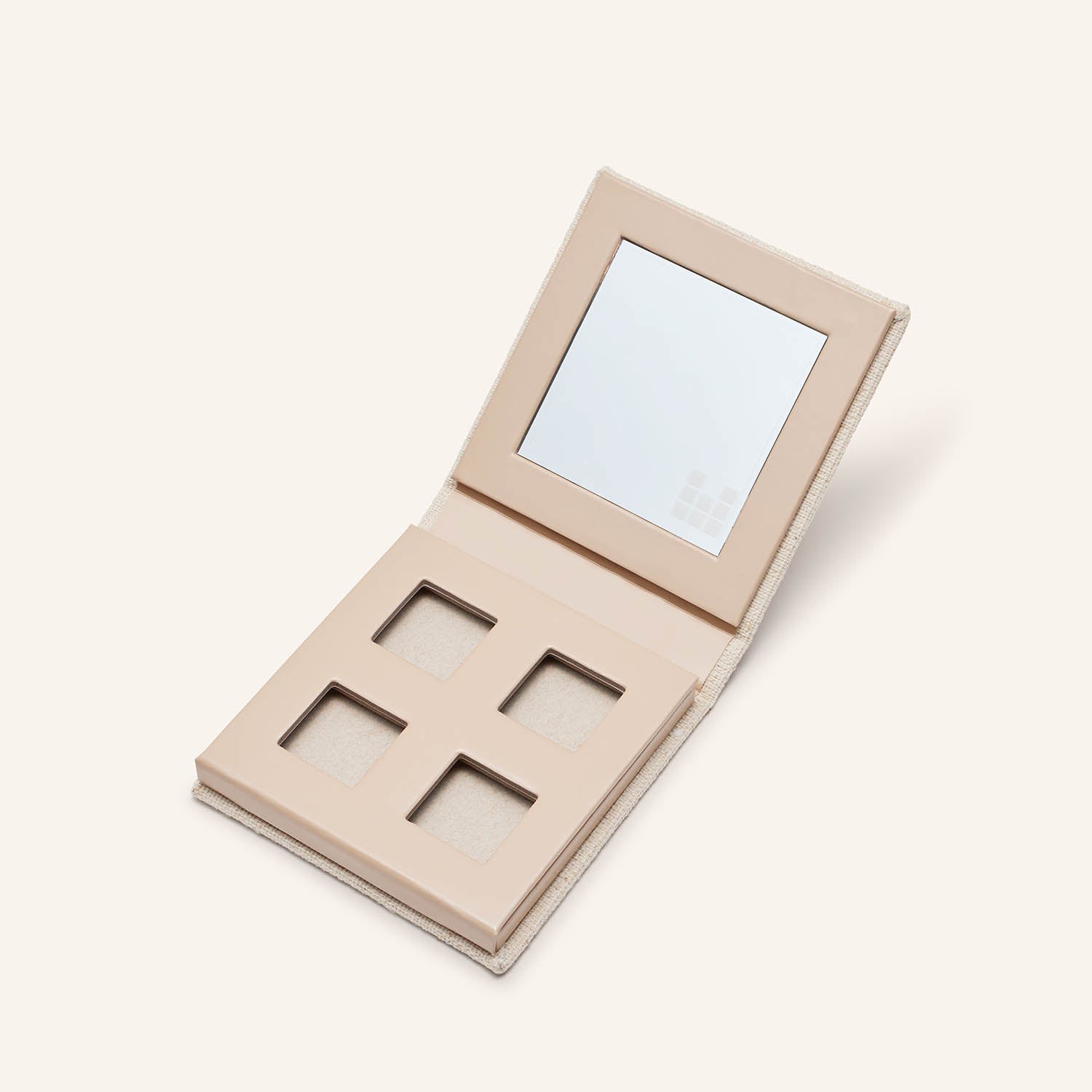 Our empty Fold out eyes® palette open showing mirror and slots for eyeshadow.