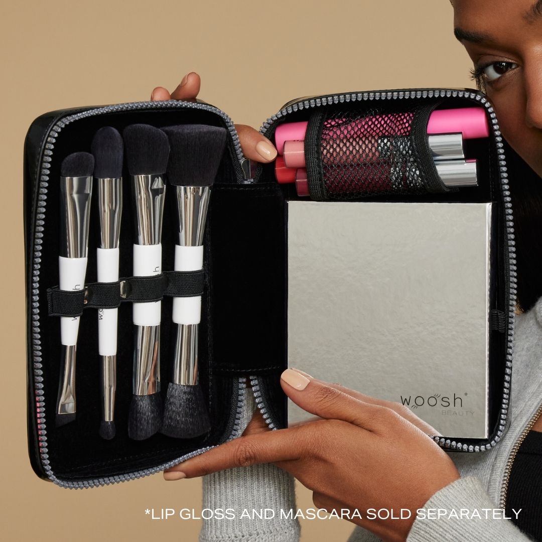 Model holding black case showing palette and brushes inside.