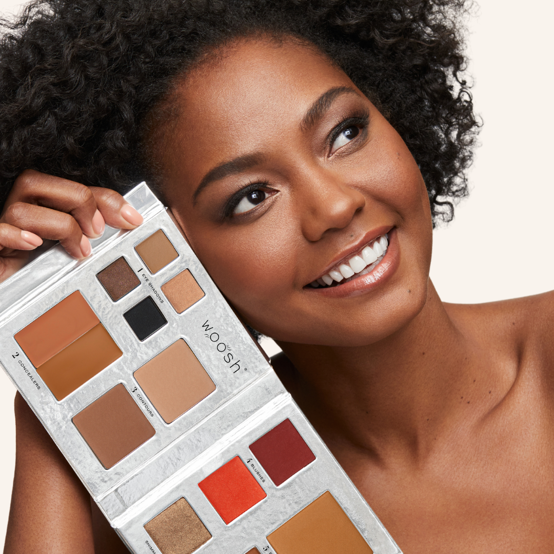 darker skinned model with Fold out face palette open showing off the product