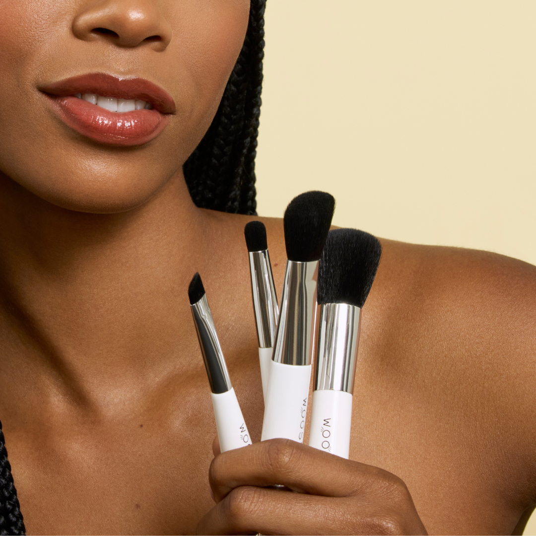 model holding our 4 dual ended essential brush set 