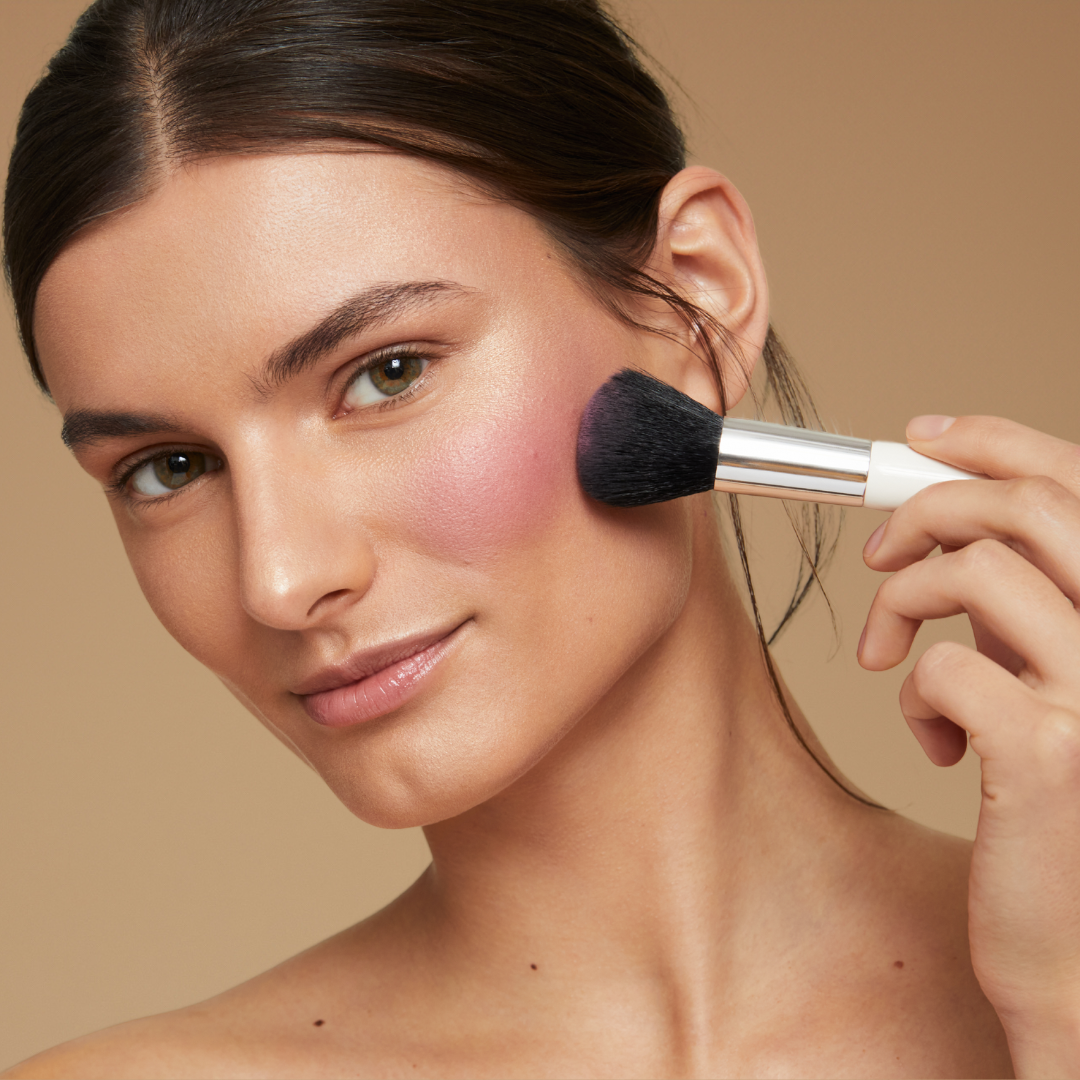 Model applying blush using the blush end of the essential blush & blend brush