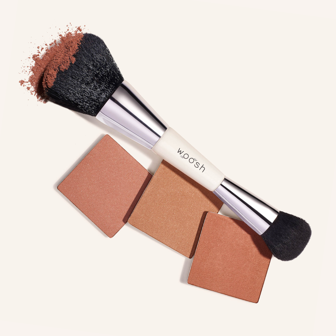 Two sided complexion foundation brush with one larger and densely packed head and one fluffy small end with silver accents