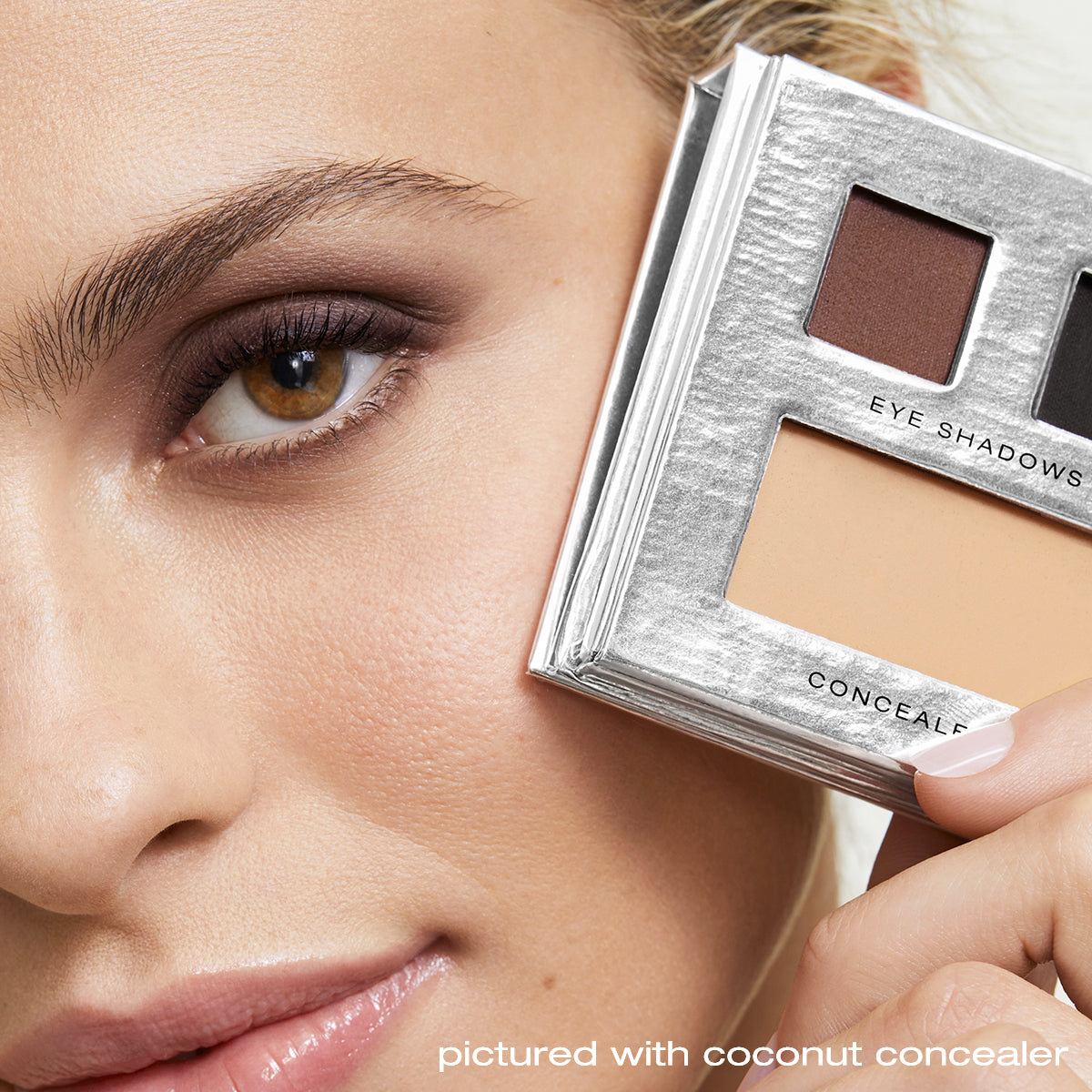 Model holding the Smokey Eye Palette with coconut concealer