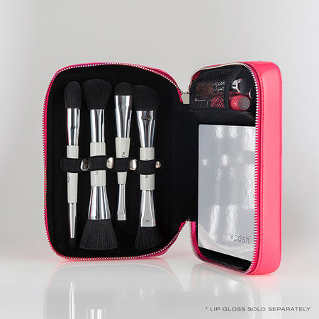 a photo of a pink makeup cases with 4 brushes and a palette inside