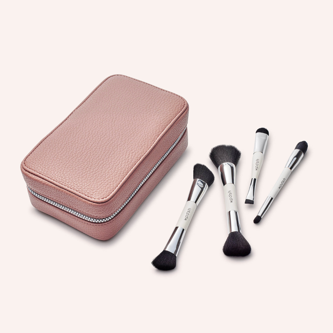 Our mauve luxe fold out case made from vegan pebbled letter. Next to the case is out Essential brush set which includes 4 dual sided brushes that are handmade, vegan and synthetic fibers