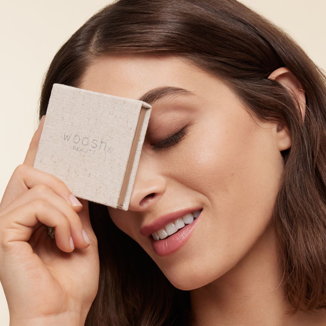 model holding fold out eyes® palette up to face 