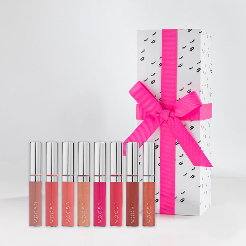 Eight spin on lip glosses included in the boss gloss set packaged in decorative black and white packaging with a pink bow