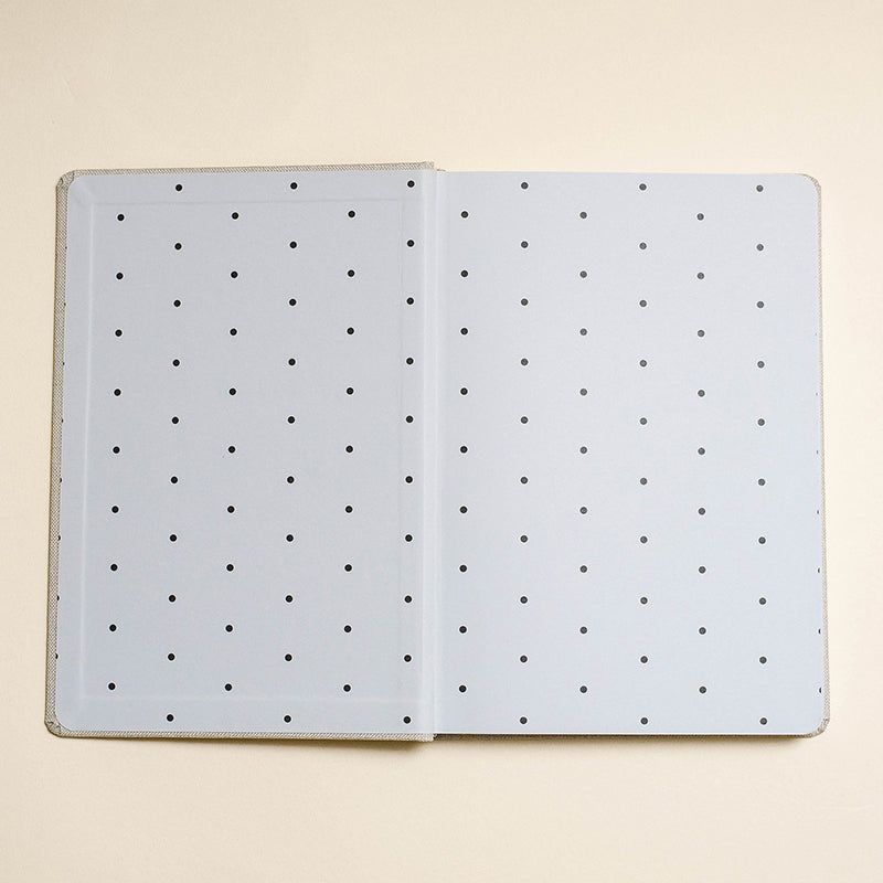 Inside cover of the notebook with black decorative dots