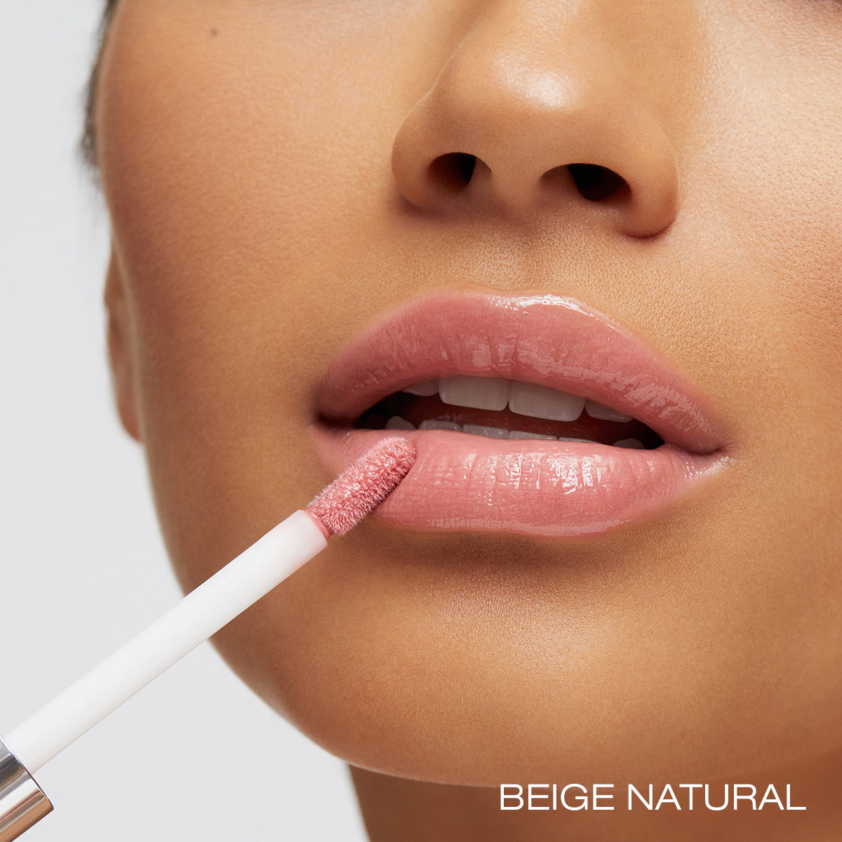 Beige Natural spin on lip gloss applied to lips demonstration