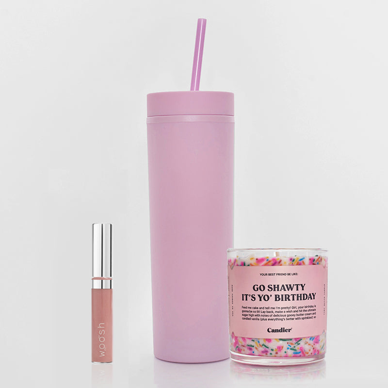 Woosh pink Beige Frosted Spin on lip gloss with shimmer, matte pink tumbler with straw, and clear birthday candle with sprinkles 
