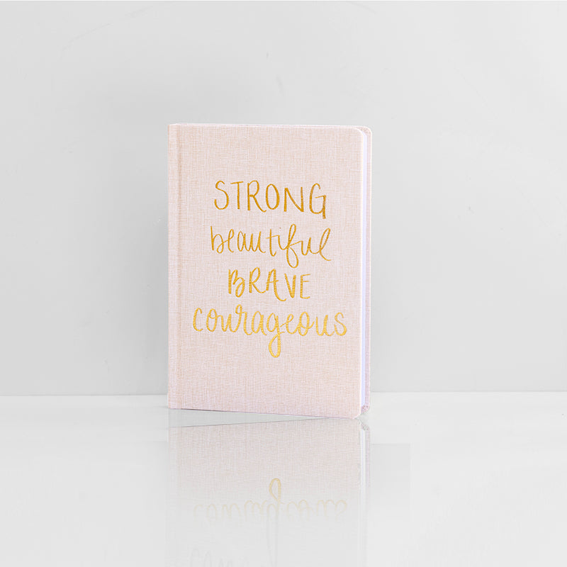 Strong, beautiful, brave, courageous notebook with tan fabric binding and gold letters
