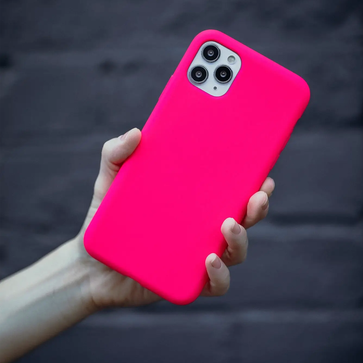 Model holding the Woosh Pink Silicone iPhone Case 