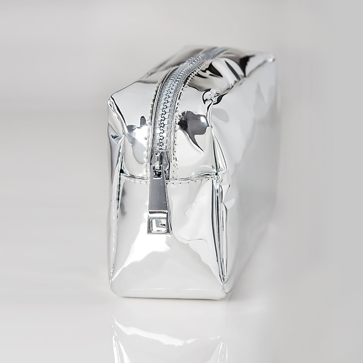 Side view of the silver essential makeup bag by Woosh Beauty